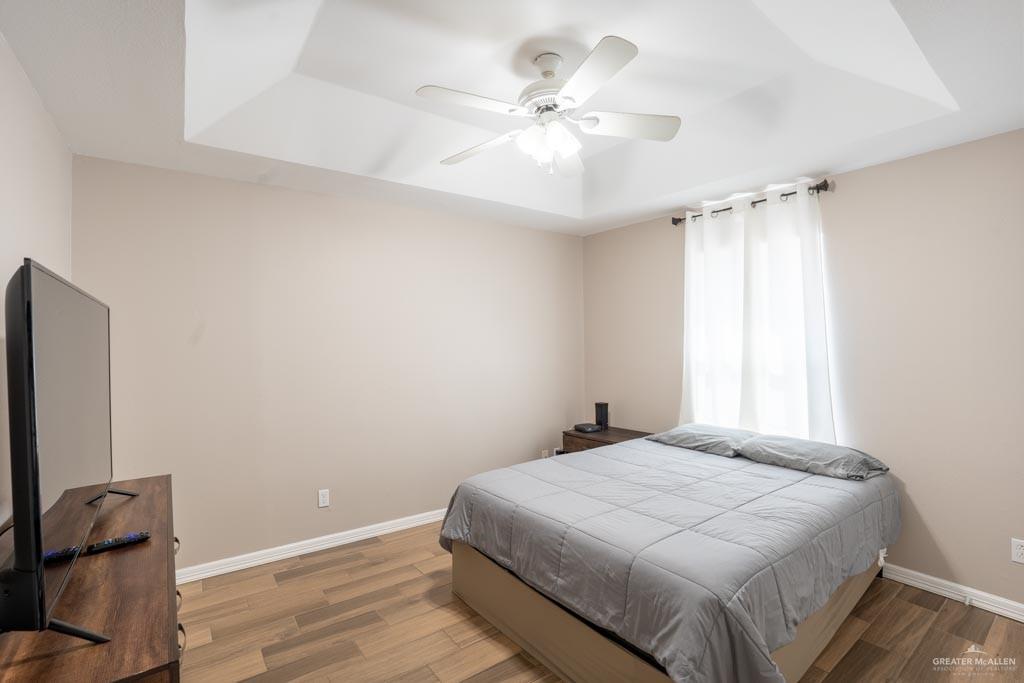 5108 South 33rd Street McAllen, TX 78503 - Photo 10 of 17 a bedroom with a large bed and a chandelier