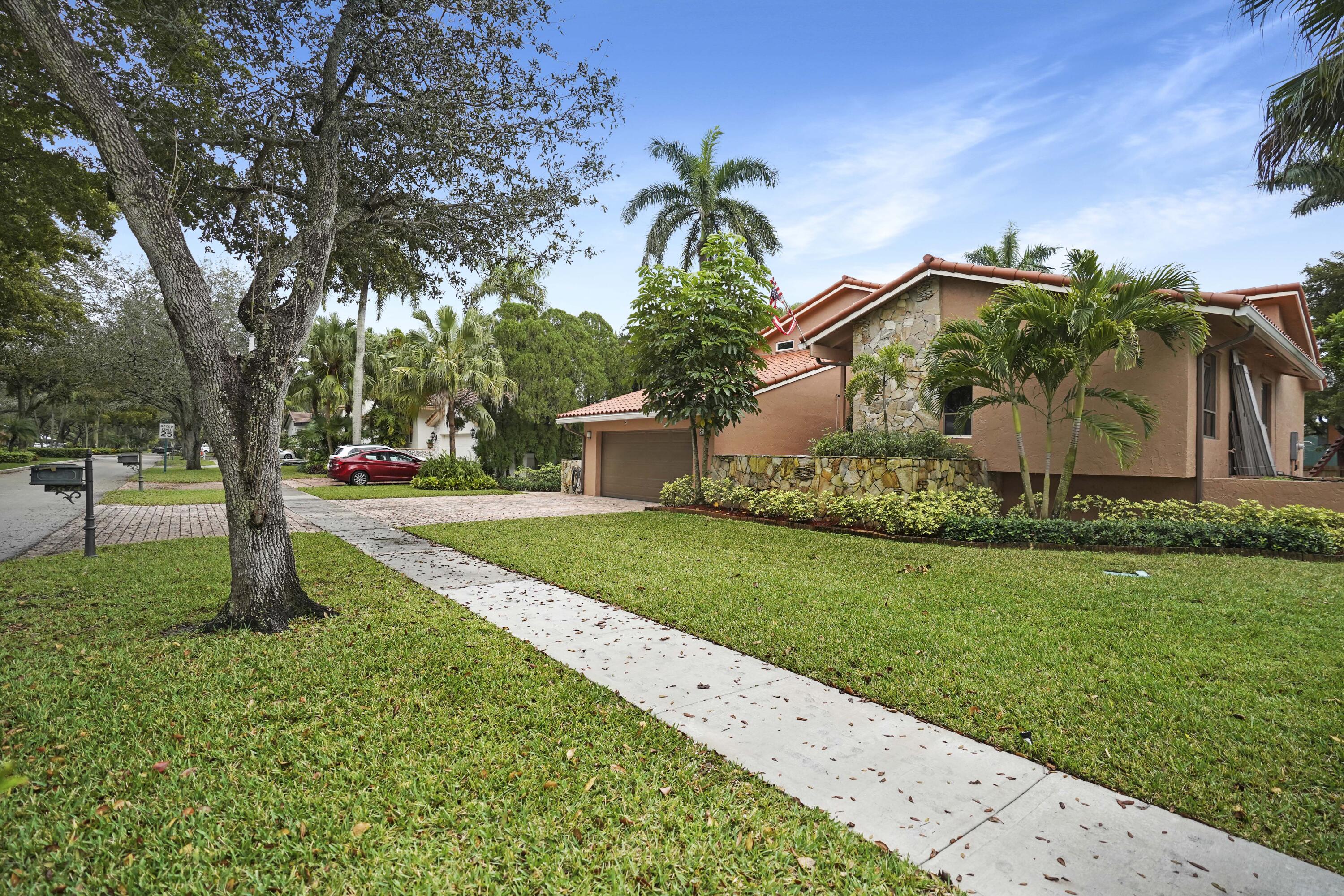 2674 Northwest 41st Street Boca Raton, FL 33434 - Photo 3 of 48 a front view of a house with garden