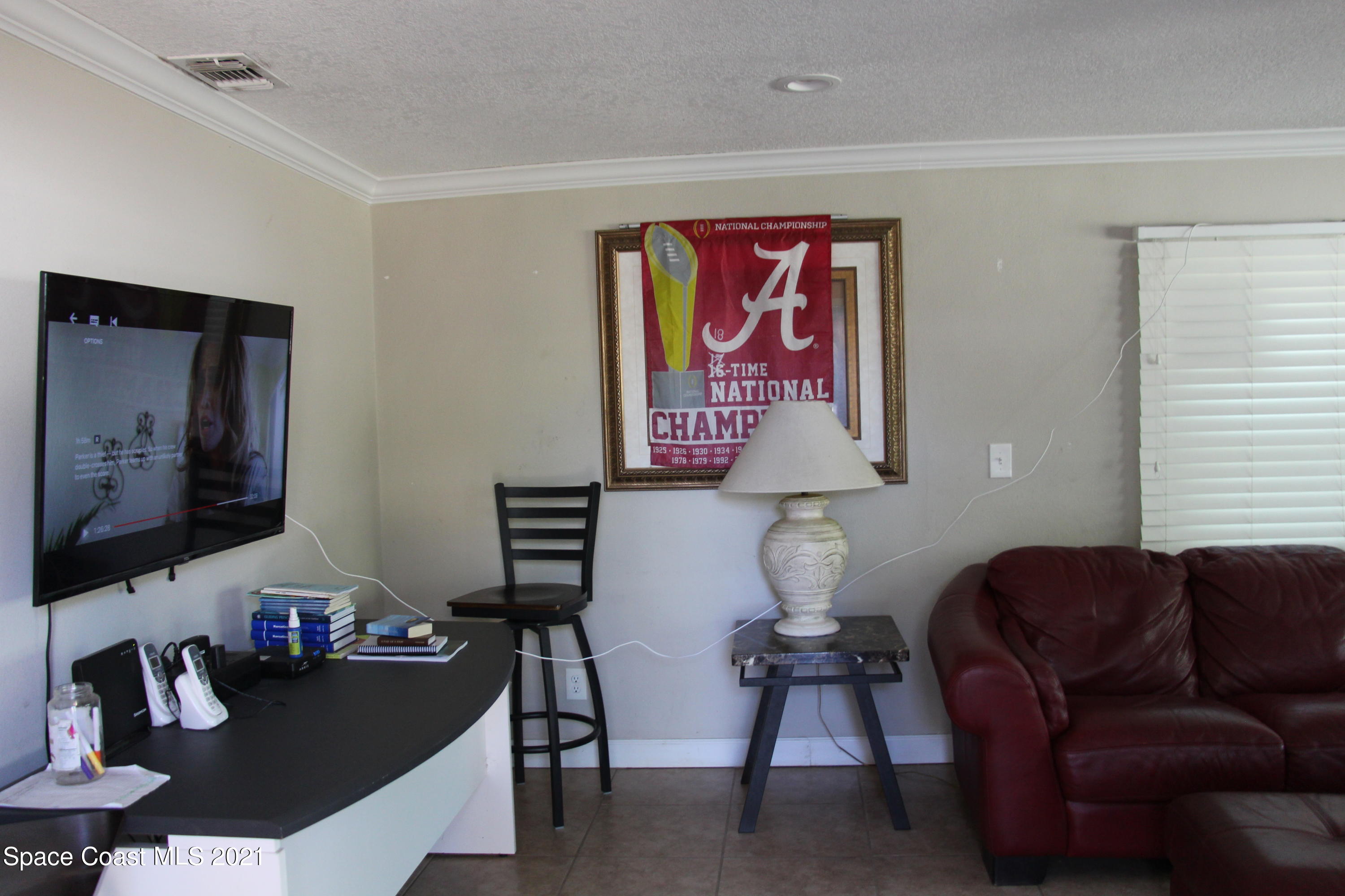 1013 South Wickham Road West Melbourne, FL 32904 - Photo 2 of 16 a living room with furniture and a flat screen tv