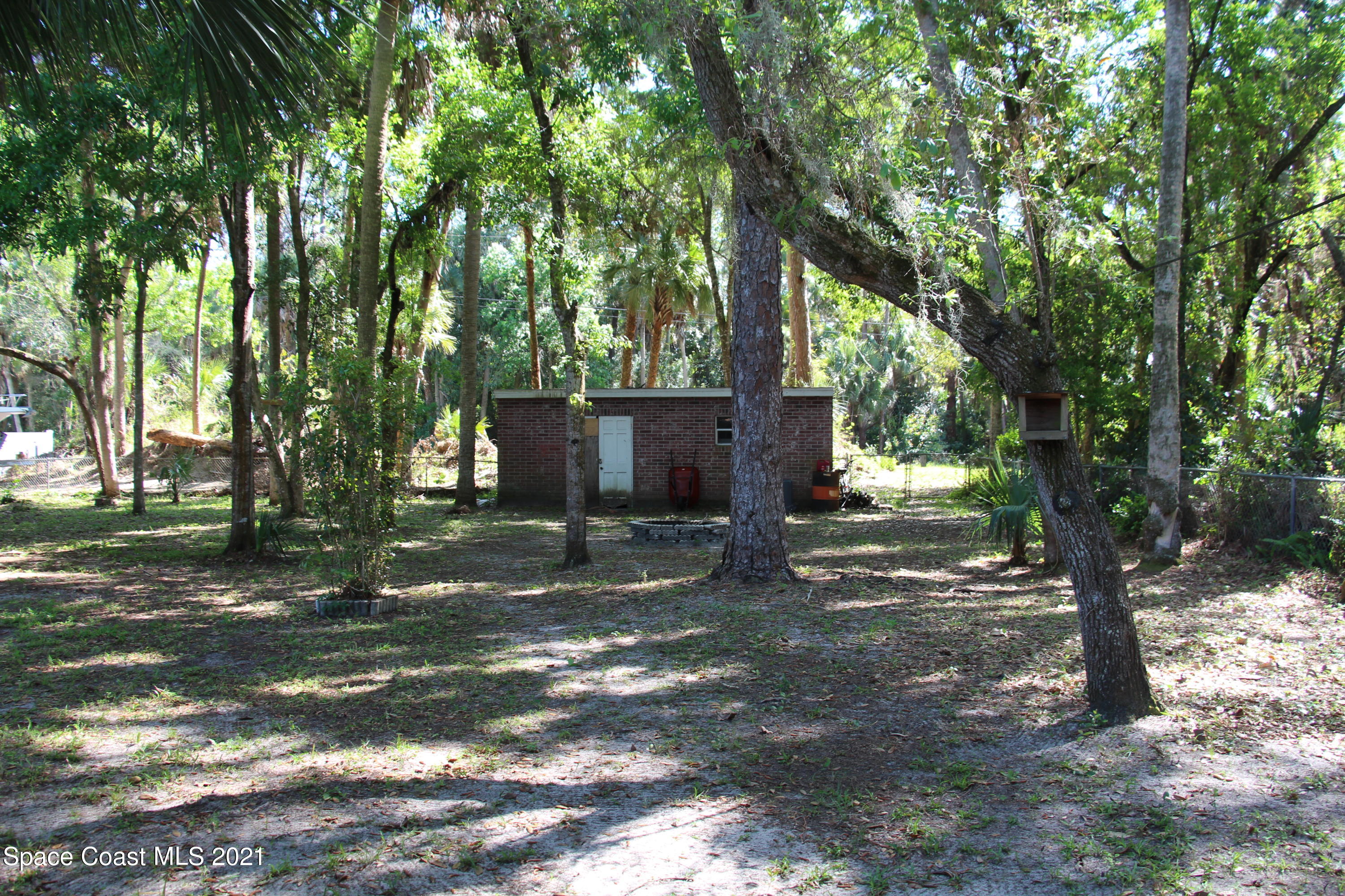 1013 South Wickham Road West Melbourne, FL 32904 - Photo 14 of 16 a view of a tree in the middle of a yard