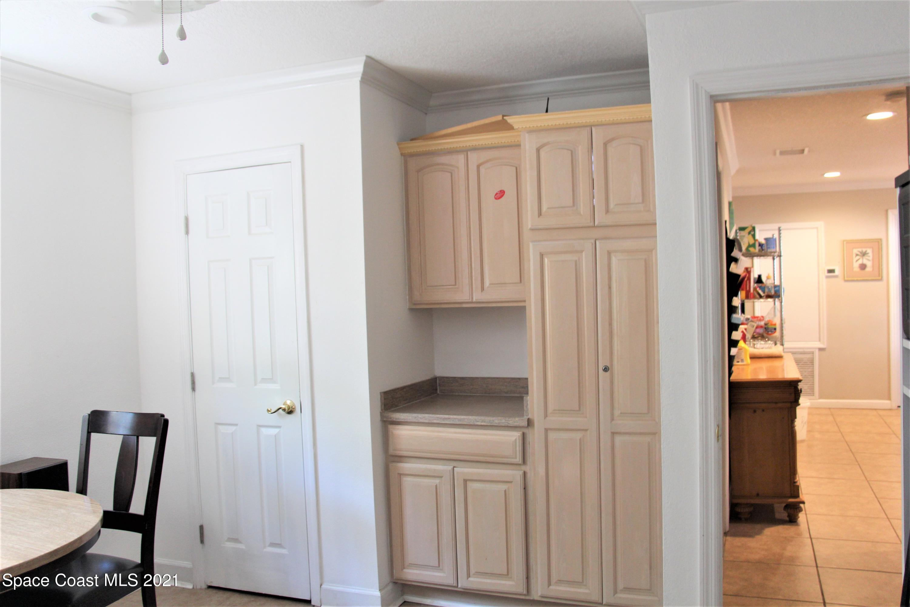 1013 South Wickham Road West Melbourne, FL 32904 - Photo 5 of 16 a view of kitchen with cabinets and wooden floor