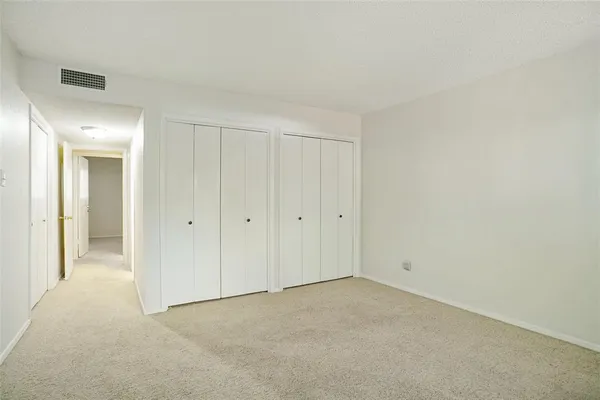 a view of an empty room and closet area