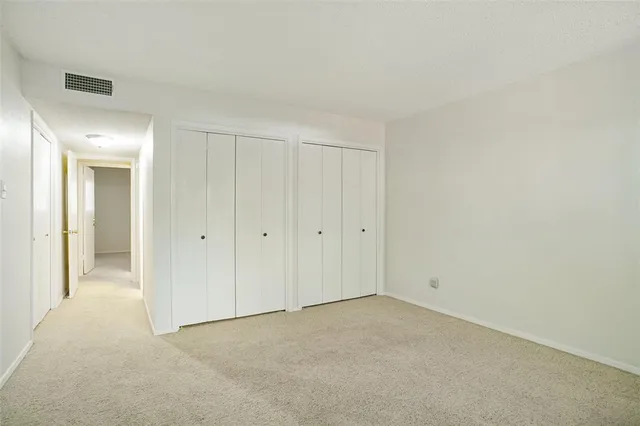 a view of an empty room and closet area
