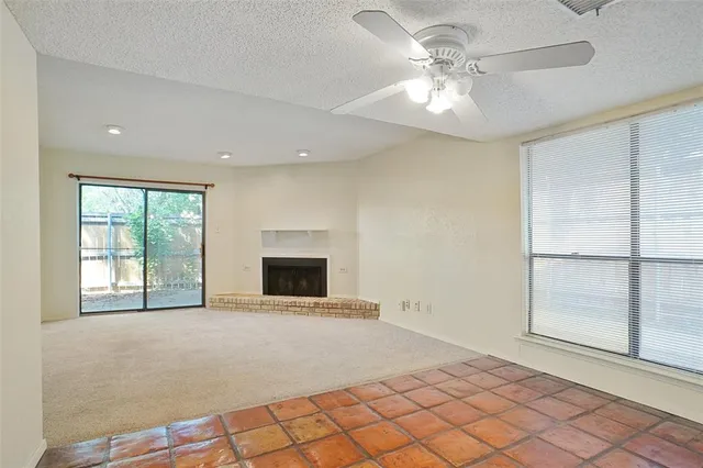 a view of an empty room with a fireplace