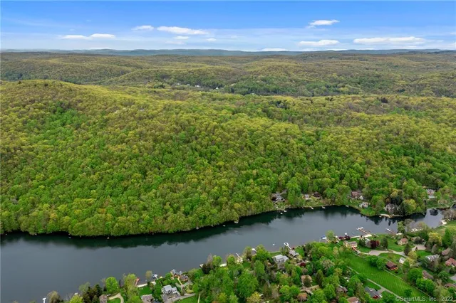 a view of a lake with beach and outdoor space