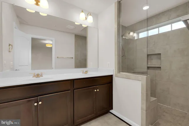 a bathroom with a double vanity sink and a mirror