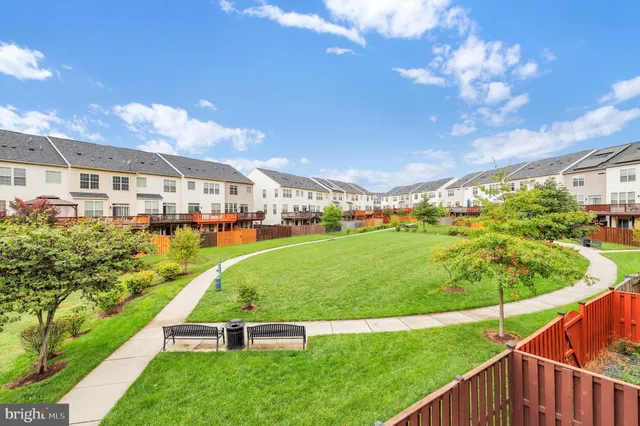 a view of yard with swimming pool and green space