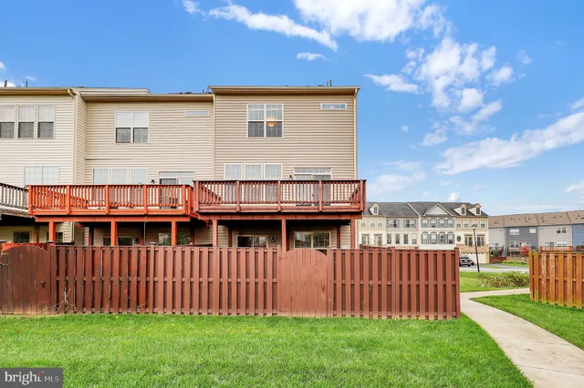 a view of a house with a wooden fence