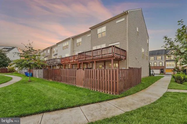 a view of backyard with barbeque grill and wooden fence