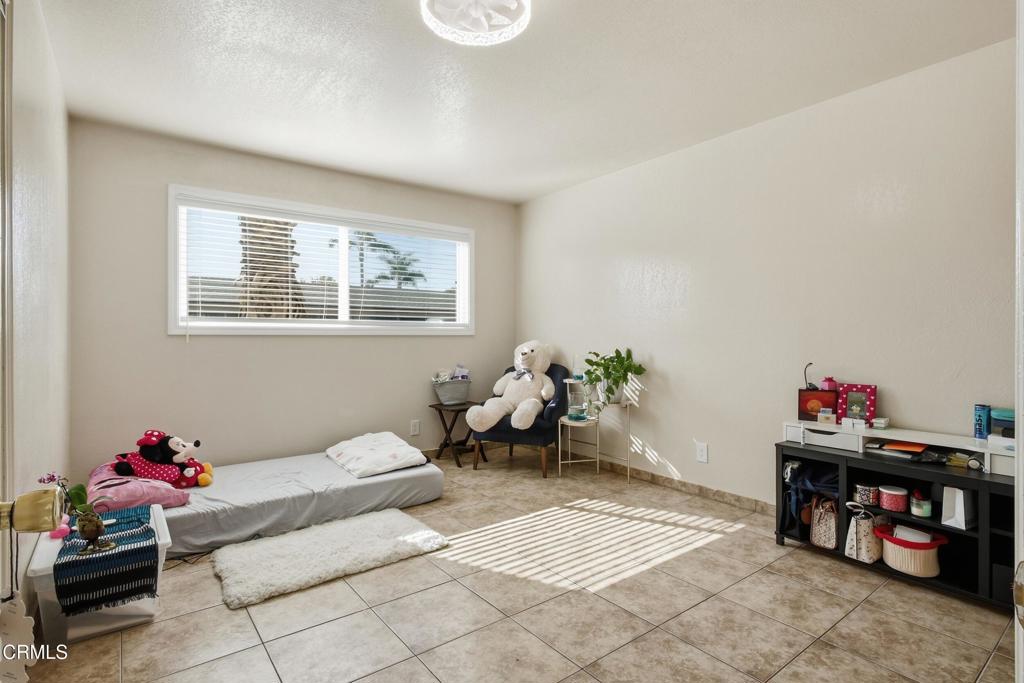 1920 North H Street, Unit 133 Oxnard, CA 93036 - Photo 7 of 14 a bedroom with furniture and a potted plant
