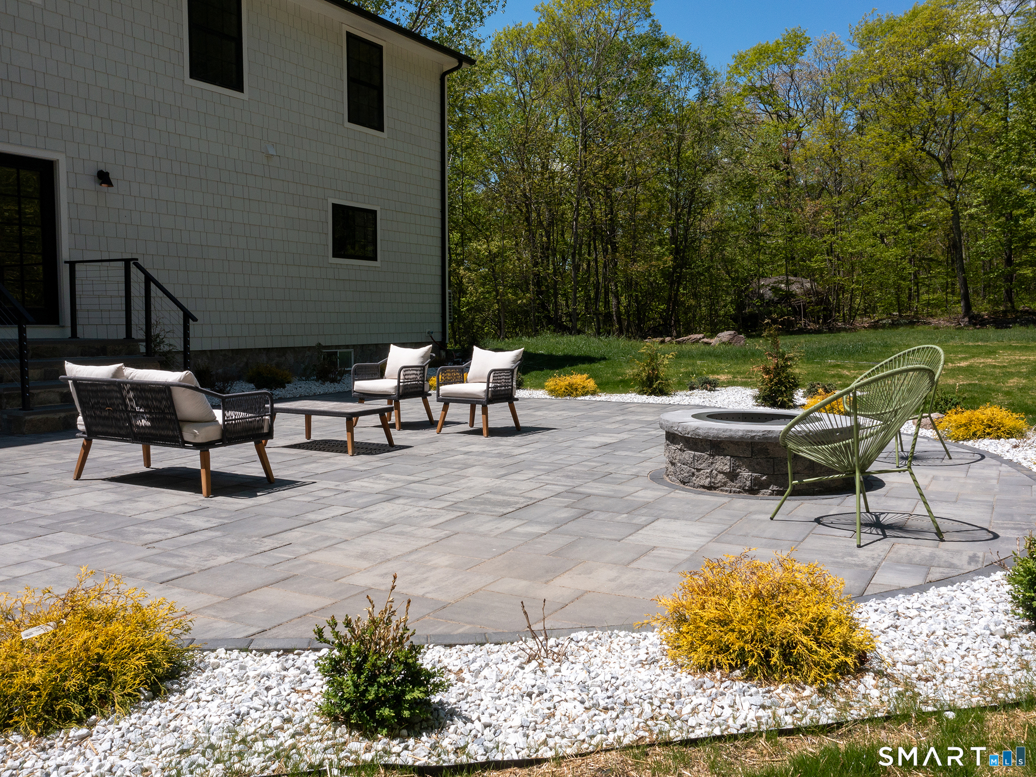 53 Mountain Lake Road Warren, CT 06777 - Photo 40 of 40 a backyard of a house with outdoor seating