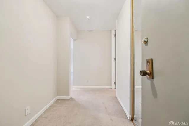 a black and white photo of a dining room with furniture and wooden floor