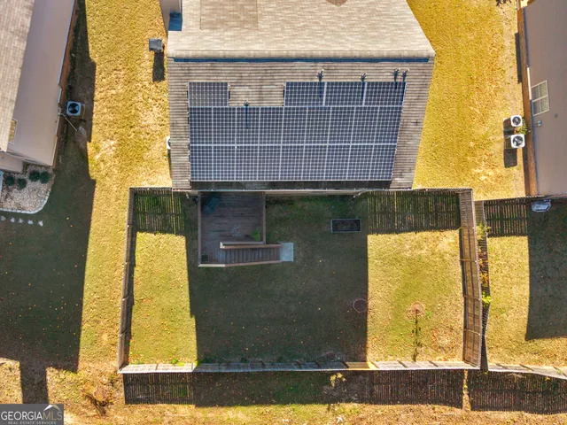 an aerial view of a house with a yard and sitting space