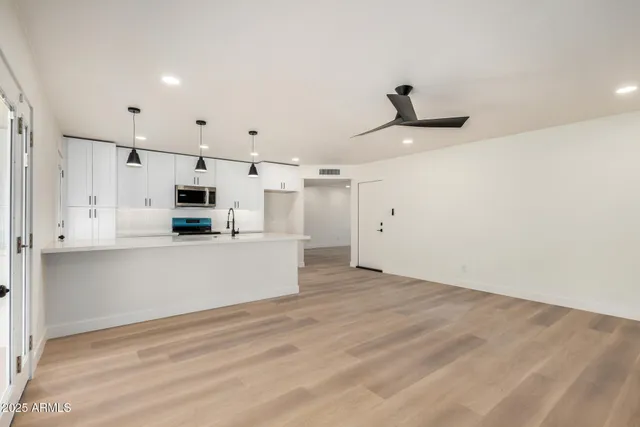 a view of kitchen with microwave and cabinets