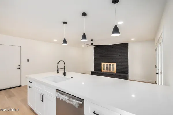 a kitchen with a sink a counter and a refrigerator