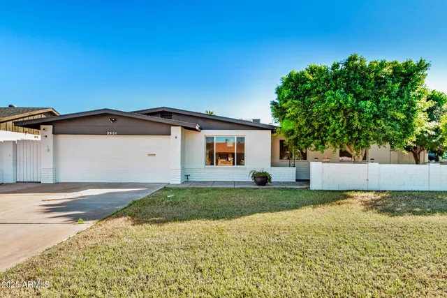 a view of a house with a yard and a garage