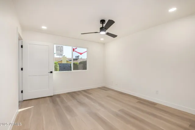 a view of empty room with ceiling fan