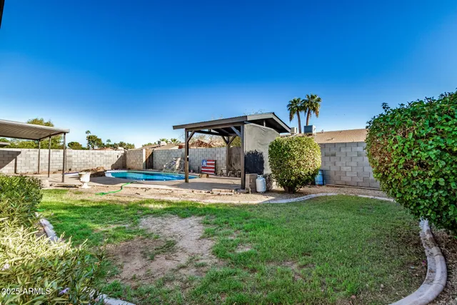 a view of a house with backyard porch and sitting area