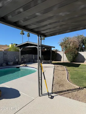 a view of backyard with tv and outdoor seating