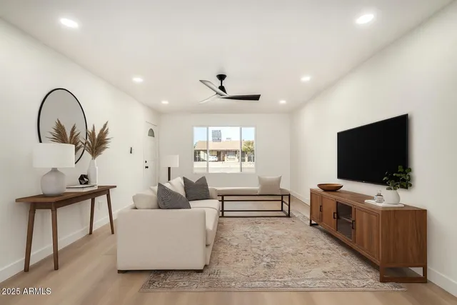 a living room with furniture and a flat screen tv