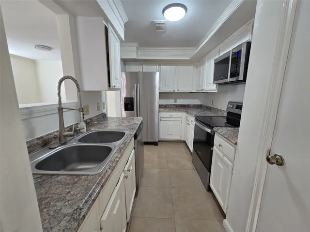 a kitchen with a sink stove and refrigerator