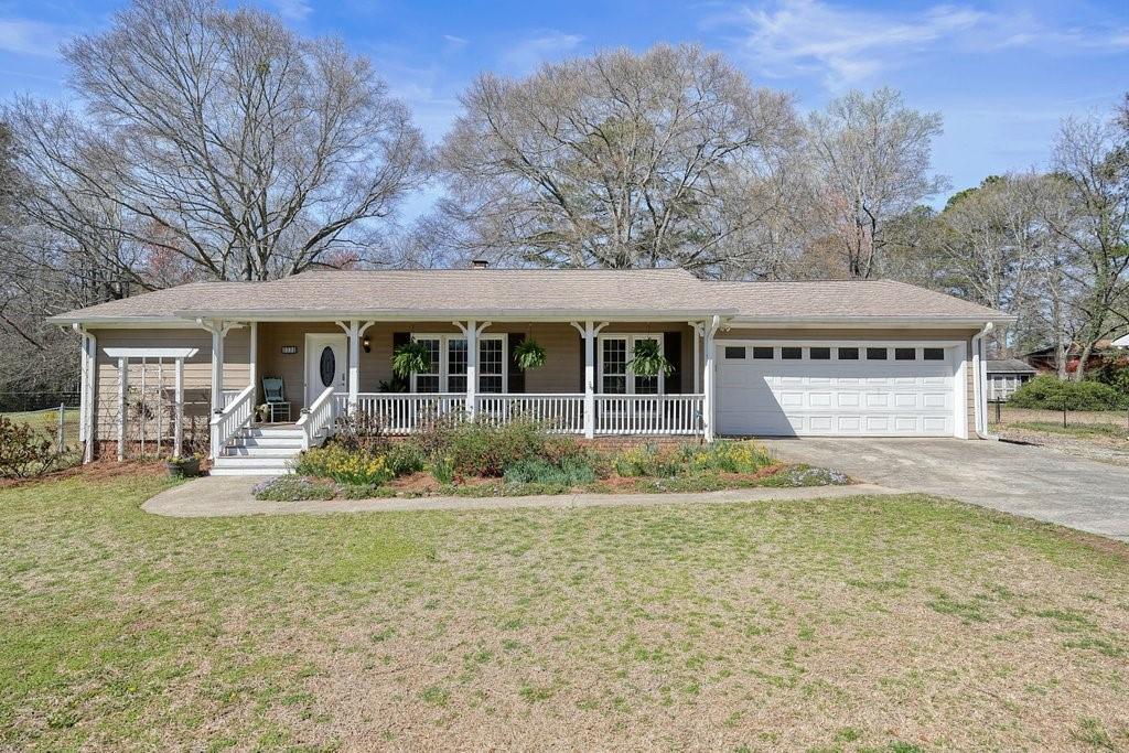 1312 Jordan Road Powder Springs, GA 30127 - Photo 1 of 1 a front view of a house with a yard