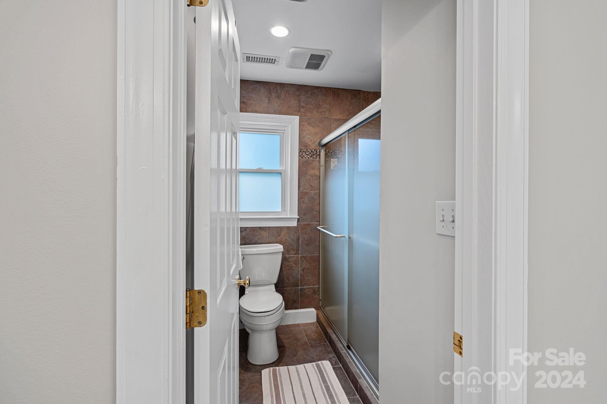 3000 Heathgate Road Charlotte, NC 28226 - Photo 20 of 48 a bathroom with a toilet and a shower