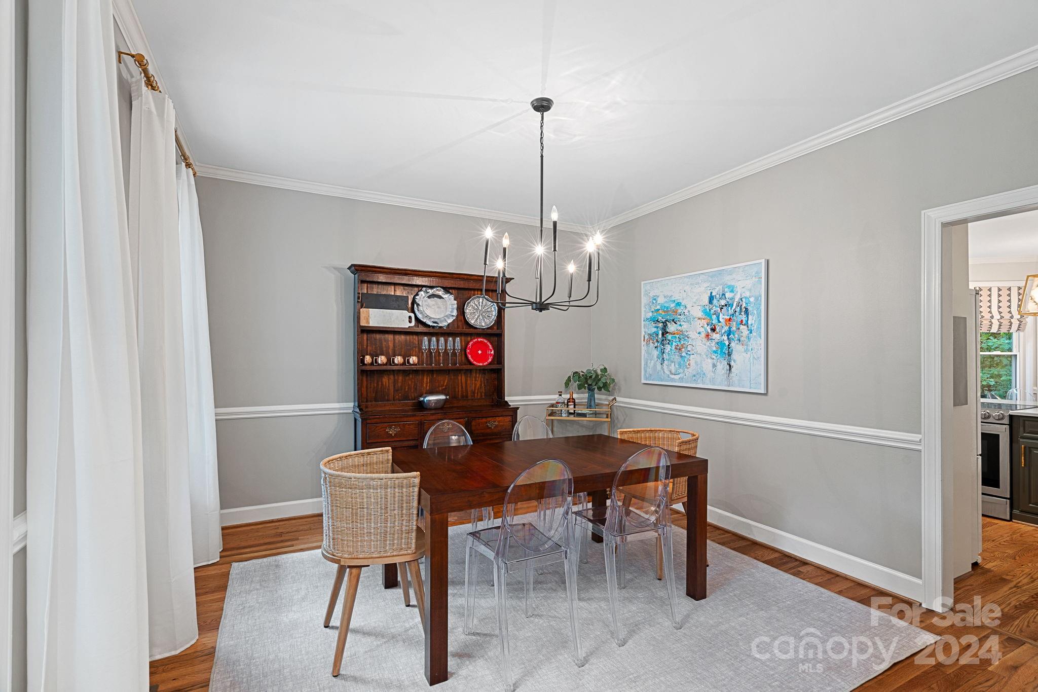 3000 Heathgate Road Charlotte, NC 28226 - Photo 10 of 48 a view of a dining room with furniture wooden floor and a chandelier