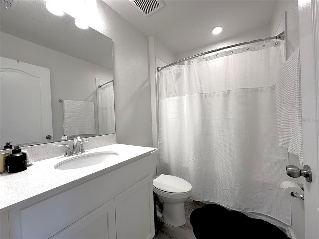 2767 North Narcoossee Road, Unit 2767 St. Cloud, FL 34771 - Photo 14 of 19 a bathroom with a sink and a mirror