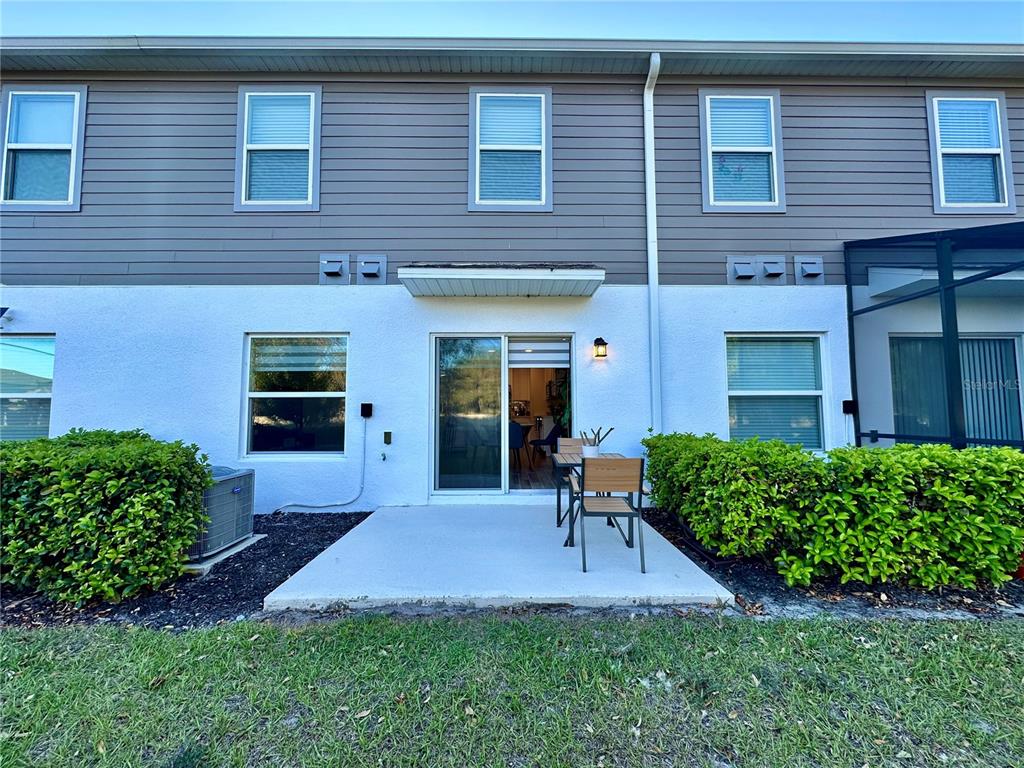 2767 North Narcoossee Road, Unit 2767 St. Cloud, FL 34771 - Photo 18 of 19 a front view of a house with a yard and outdoor seating