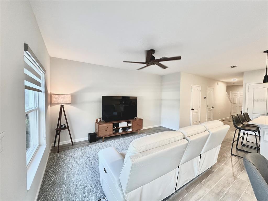 2767 North Narcoossee Road, Unit 2767 St. Cloud, FL 34771 - Photo 3 of 19 a bedroom with a bed and a flat screen tv