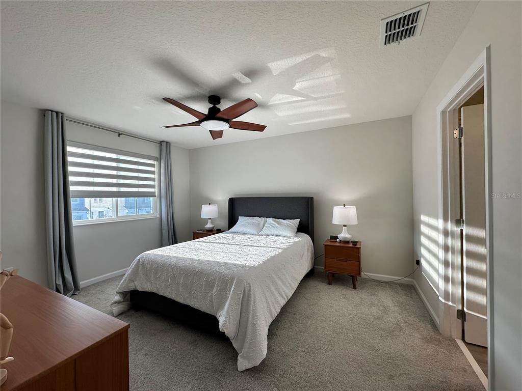 2767 North Narcoossee Road, Unit 2767 St. Cloud, FL 34771 - Photo 9 of 19 a bedroom with a bed and a window