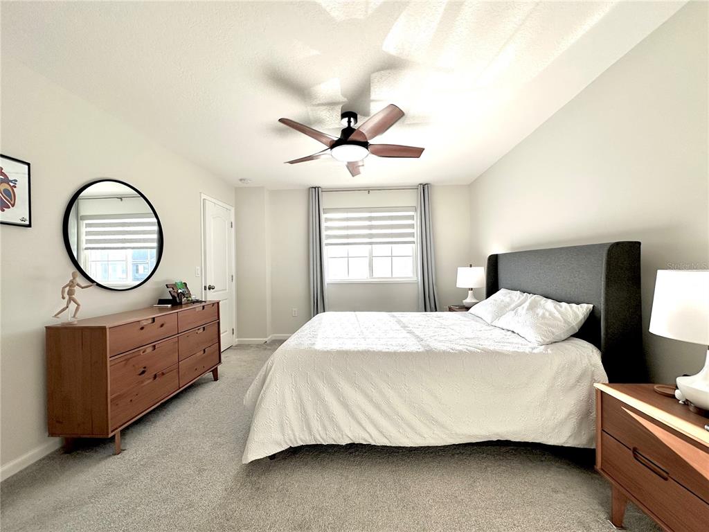 2767 North Narcoossee Road, Unit 2767 St. Cloud, FL 34771 - Photo 10 of 19 a bedroom with a bed and a dresser