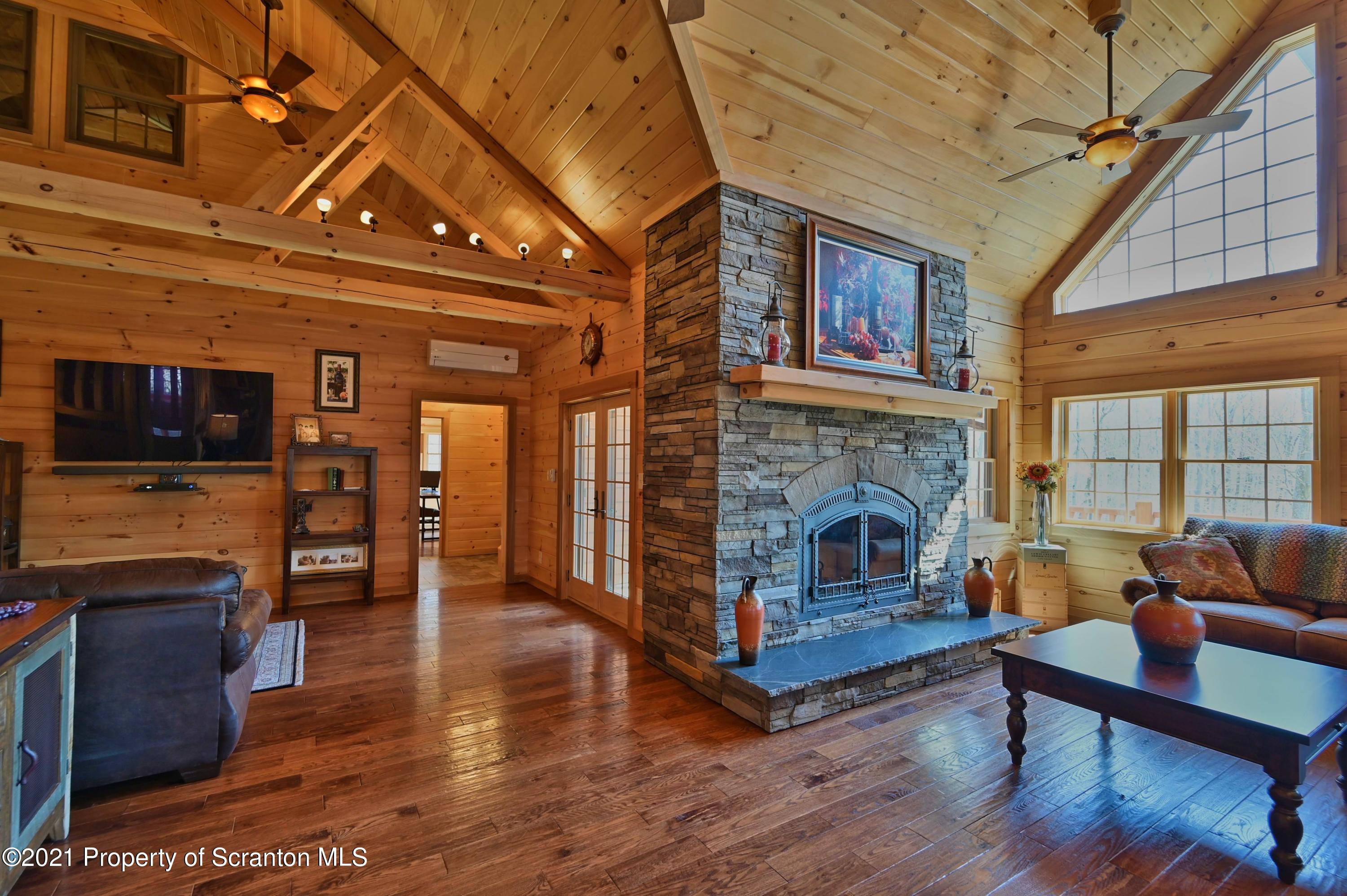 400 Summit Woods Road Moscow, PA 18444 - Photo 27 of 72 a living room with furniture and a fireplace
