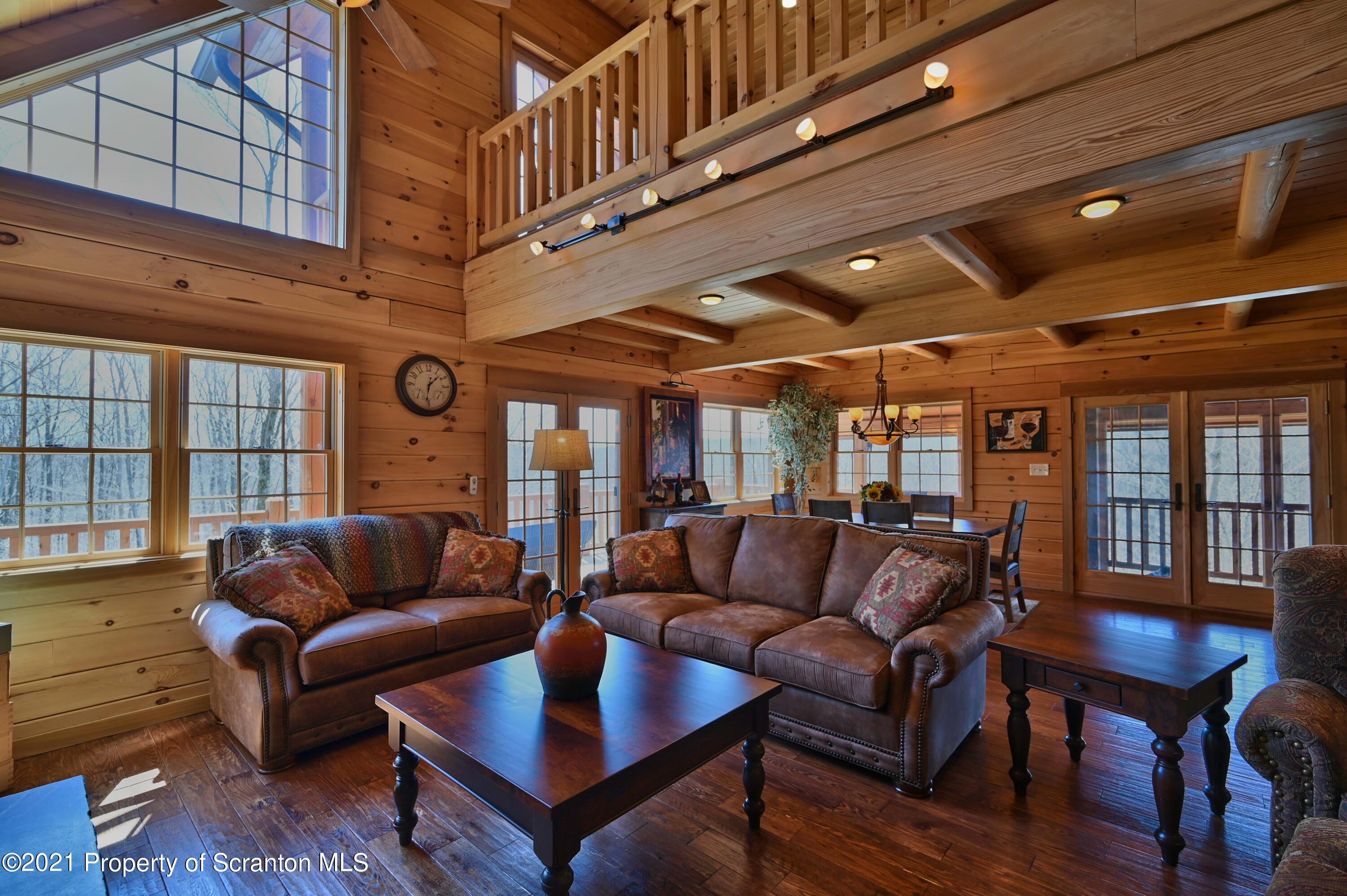 400 Summit Woods Road Moscow, PA 18444 - Photo 28 of 72 a living room with furniture a ceiling fan and a window