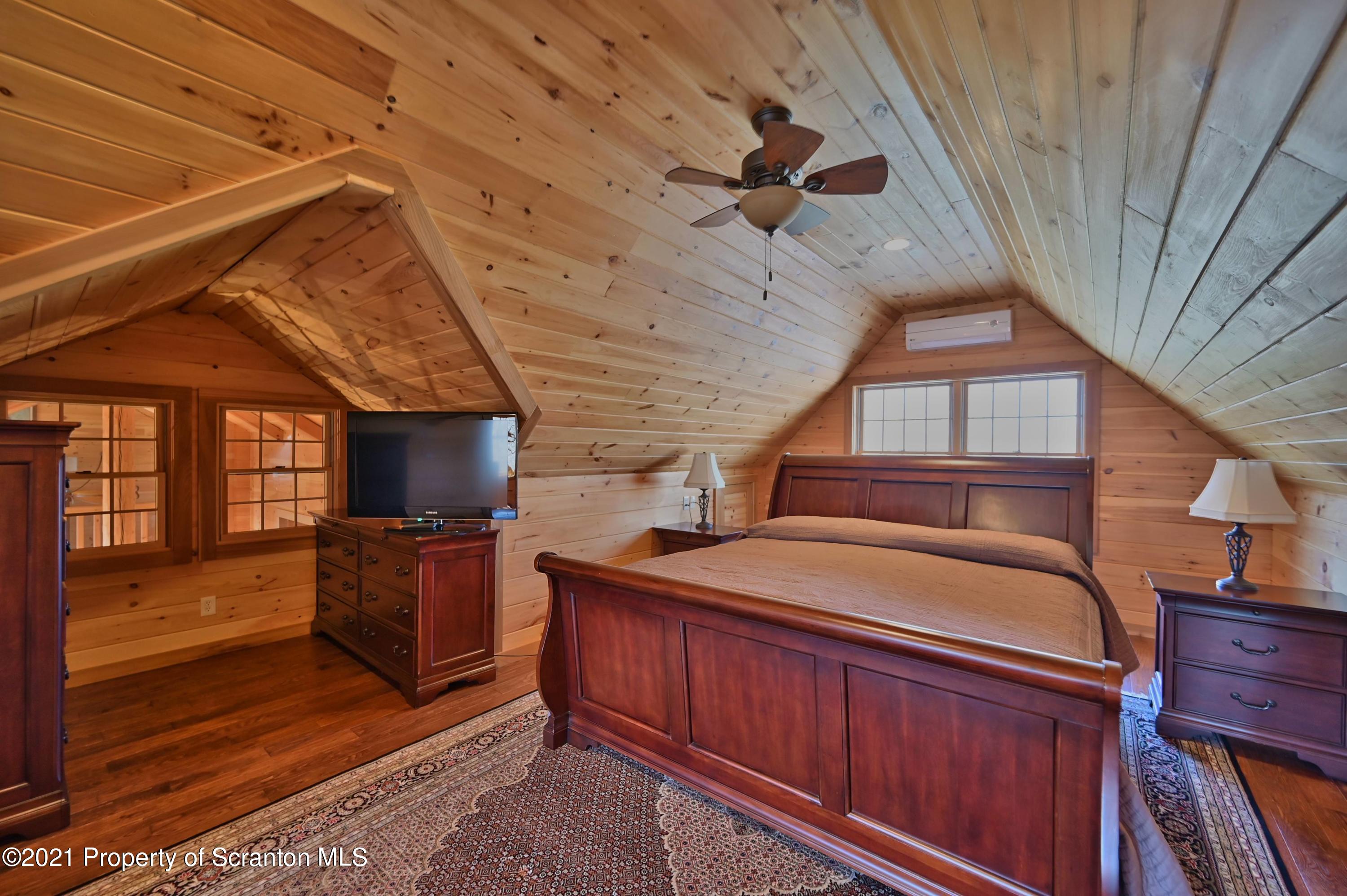 400 Summit Woods Road Moscow, PA 18444 - Photo 54 of 72 a room with furniture a flat screen tv and kitchen view