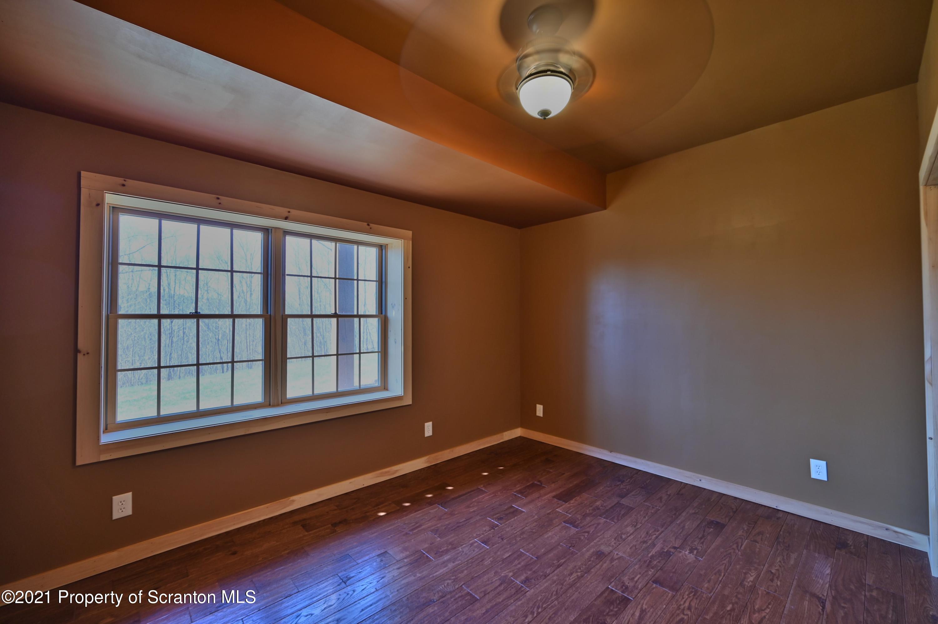 400 Summit Woods Road Moscow, PA 18444 - Photo 63 of 72 an empty room with wooden floor and windows