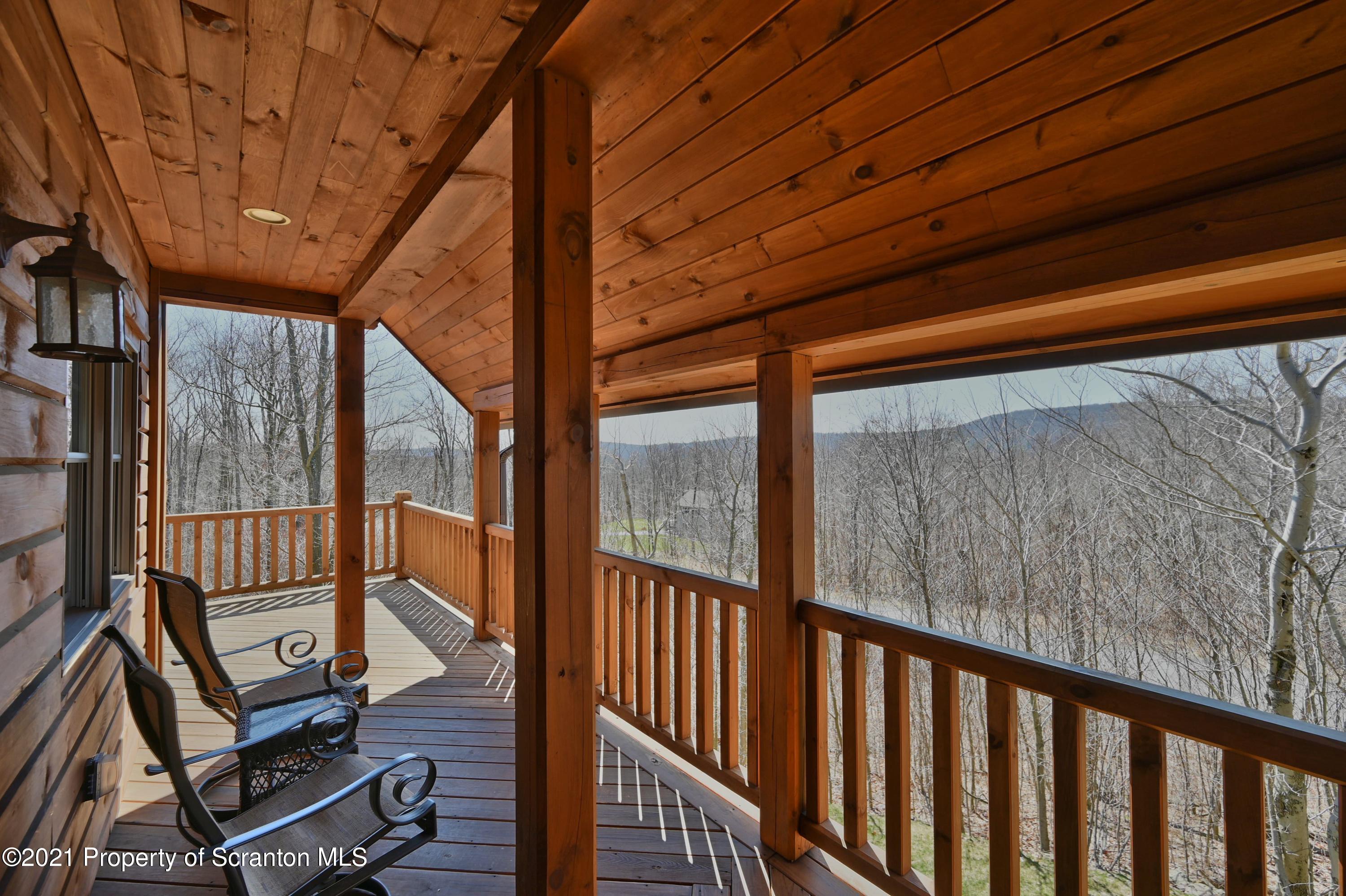 400 Summit Woods Road Moscow, PA 18444 - Photo 66 of 72 a view of a balcony with wooden floor and iron stairs
