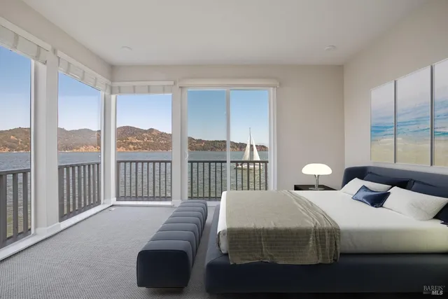 a bedroom with a bed and a large window