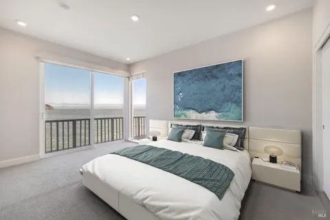 a bedroom with a large bed and a window