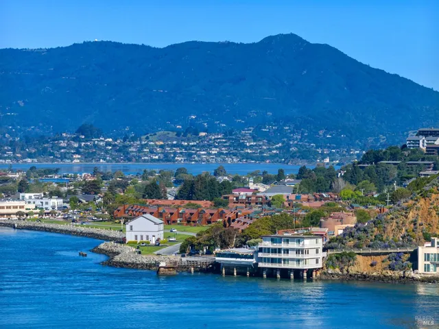 a view of a city with lots of residential buildings and mountain view in back