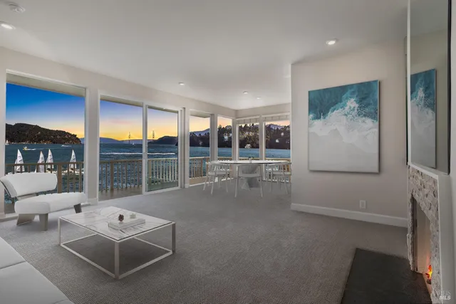 a living room with furniture and a floor to ceiling window
