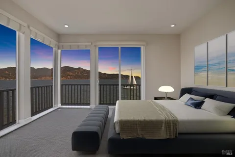 a bedroom with a bed and a large window
