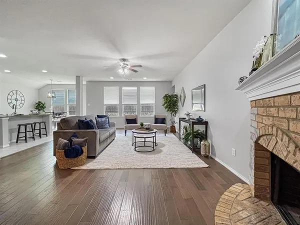 a living room with furniture fireplace and flat screen tv