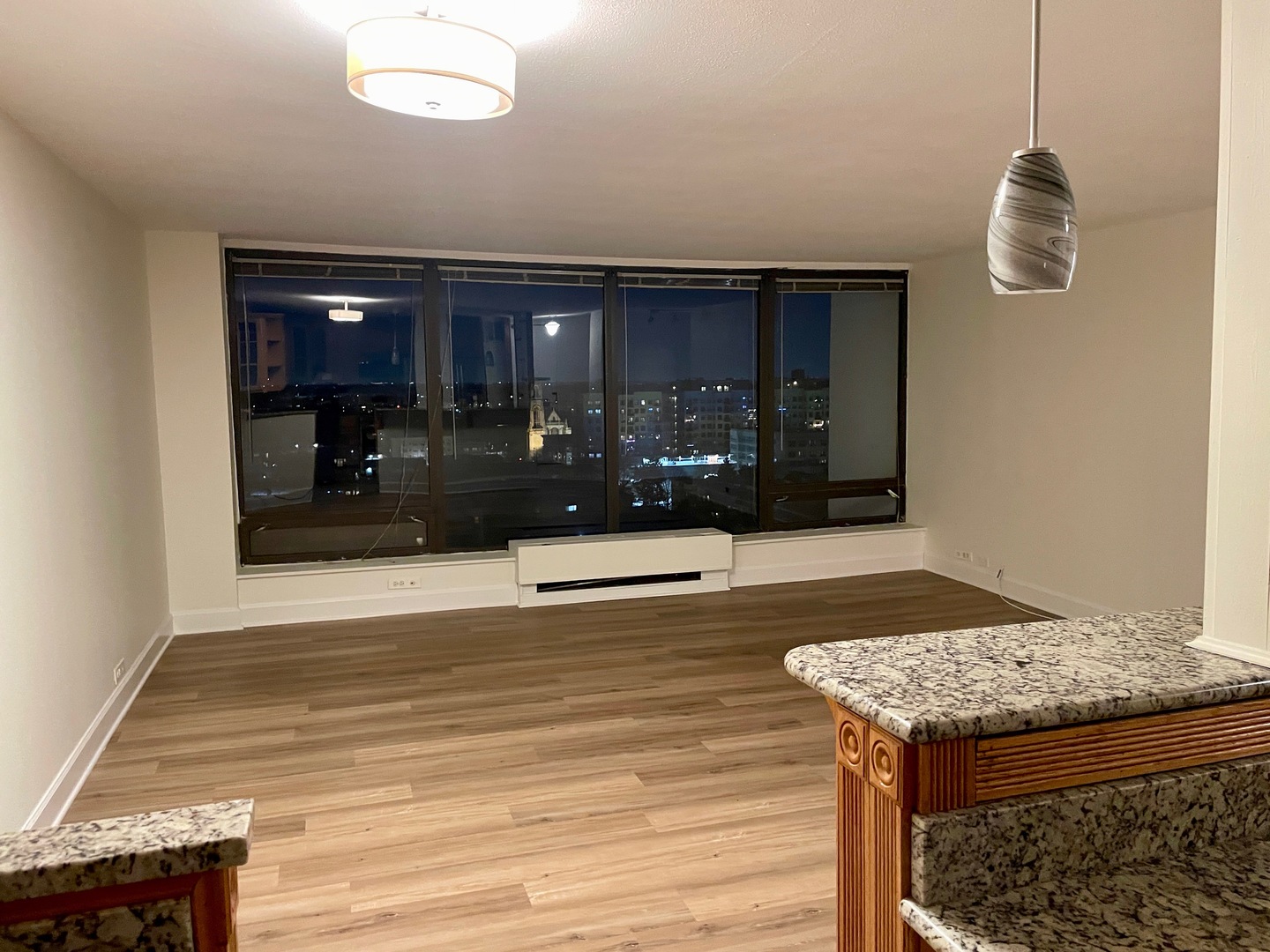 5445 North Sheridan Road, Unit 1603 Chicago, IL 60640 - Photo 20 of 40 a living room with a table and a fireplace