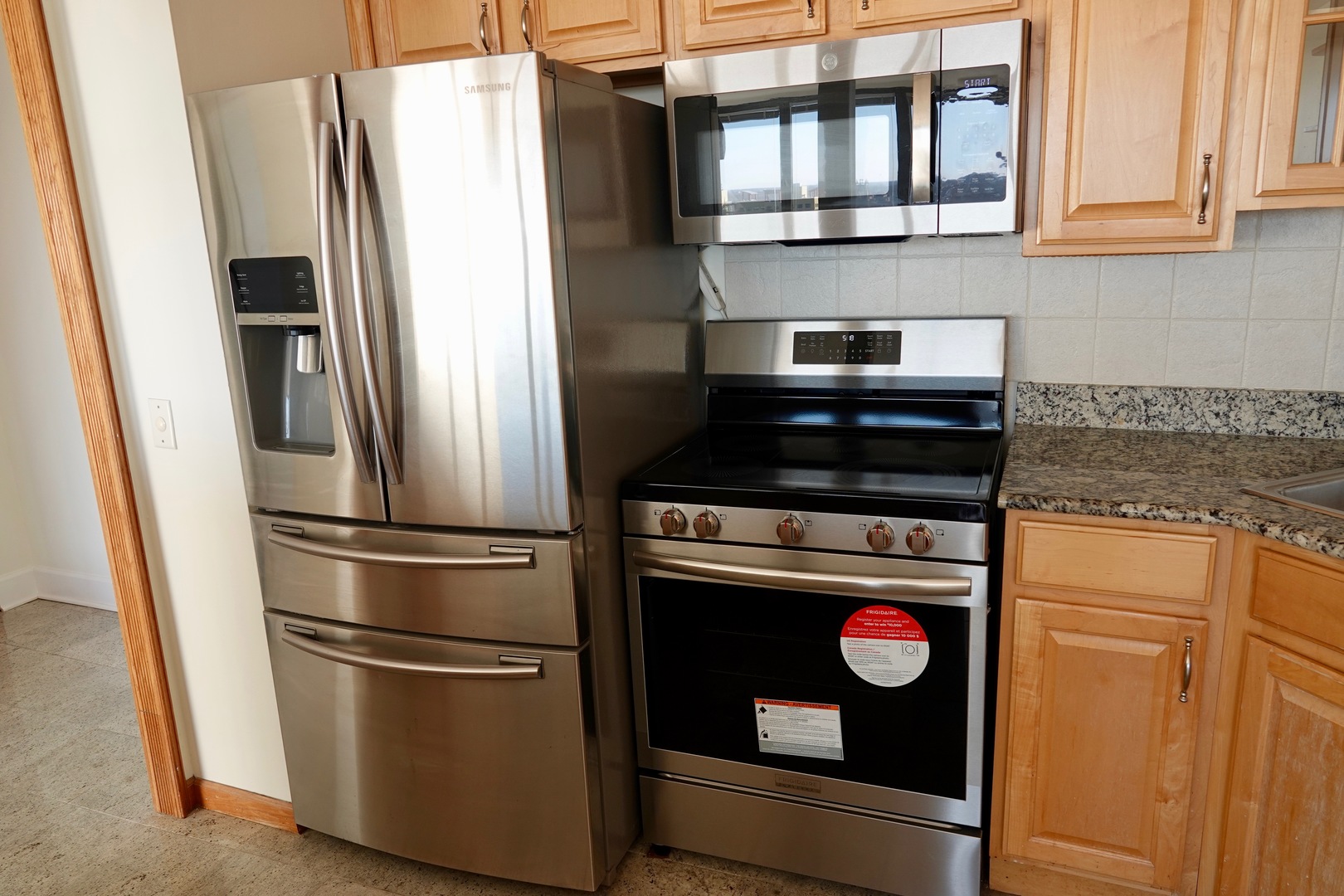5445 North Sheridan Road, Unit 1603 Chicago, IL 60640 - Photo 25 of 40 a kitchen with stainless steel appliances and a refrigerator