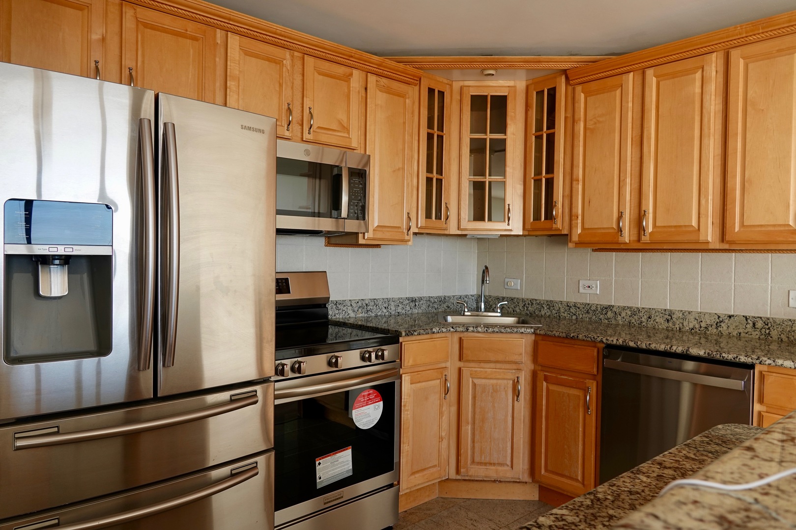 5445 North Sheridan Road, Unit 1603 Chicago, IL 60640 - Photo 29 of 40 a kitchen with stainless steel appliances granite countertop a refrigerator a stove and a sink