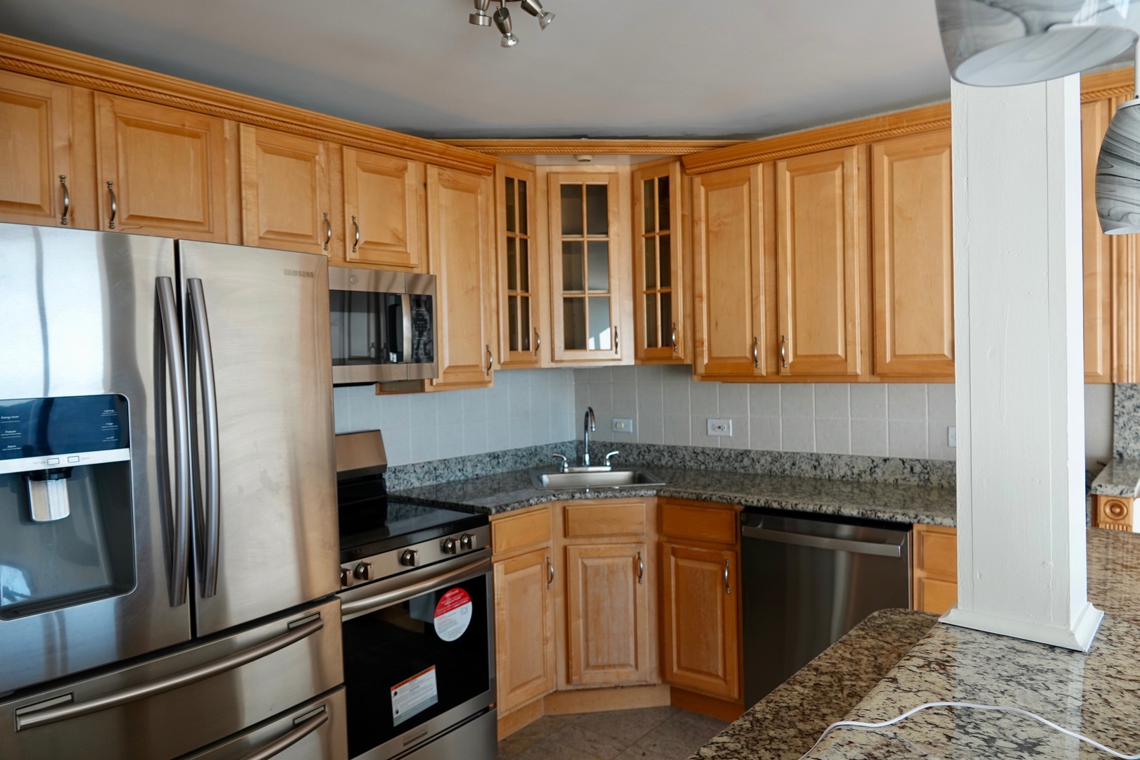 5445 North Sheridan Road, Unit 1603 Chicago, IL 60640 - Photo 30 of 40 a kitchen with stainless steel appliances granite countertop a refrigerator a stove and a sink