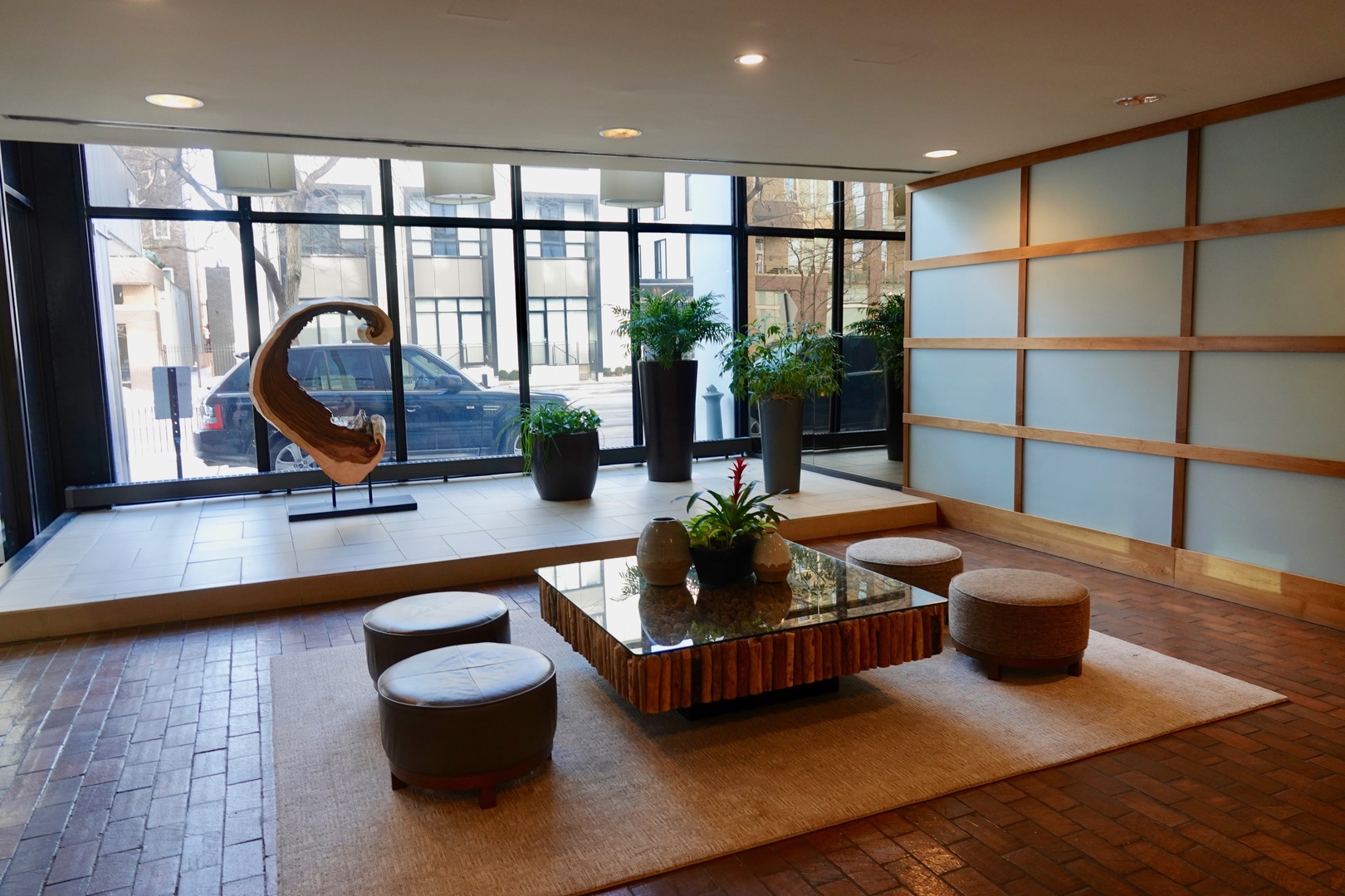5445 North Sheridan Road, Unit 1603 Chicago, IL 60640 - Photo 6 of 40 a living room with furniture a rug and a floor to ceiling window
