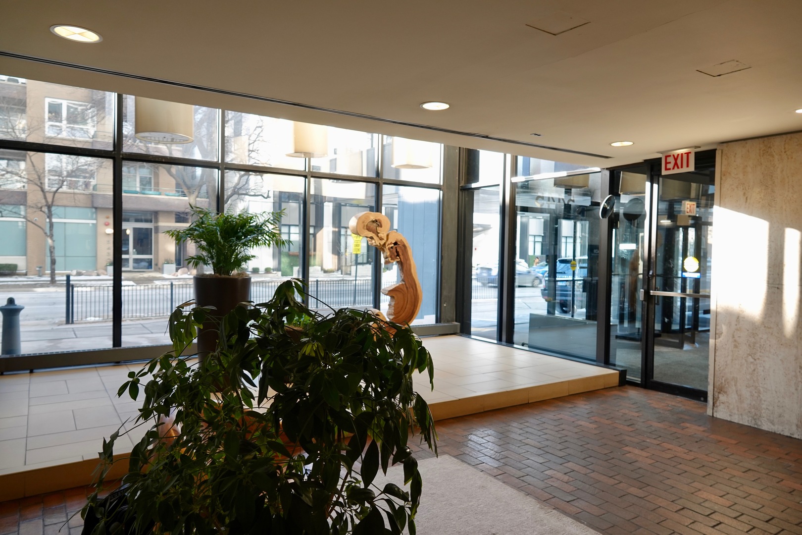 5445 North Sheridan Road, Unit 1603 Chicago, IL 60640 - Photo 8 of 40 a view of a hallway with floor to ceiling window and wooden floor